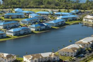 Hurricane damaged apartment buildings rooftops covered with protective plastic tarp