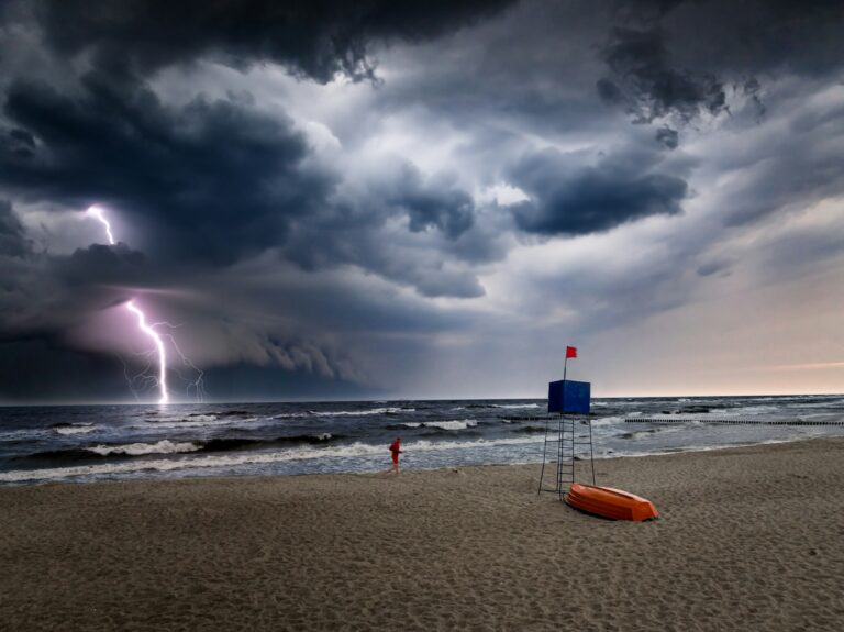 Running rescuer to lifeguard tower at Baltic Sea during storm