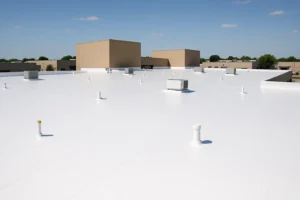 Roofing crew installing TPO roof on Houston commercial building